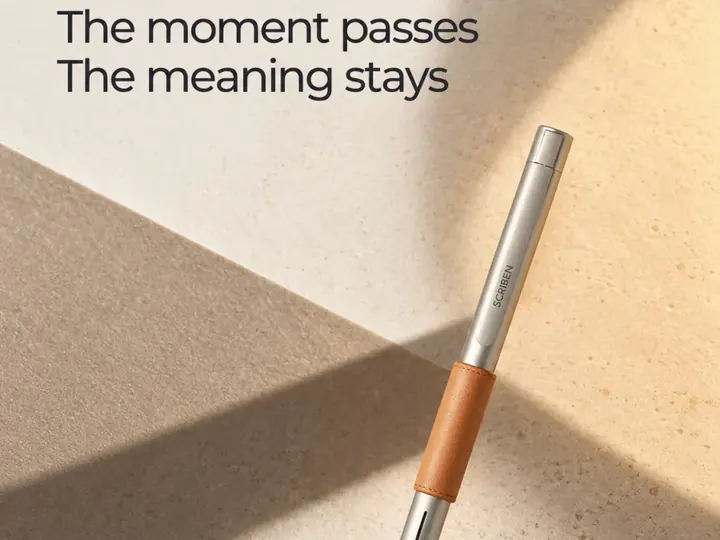 The moment passes. The meaning stays. A Scriben pen resting on sand.